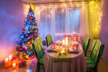 Colorful Christmas table setting with gifts and gingerbread