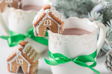 Closeup of hot cocoa and gingerbread cottages for Christmas