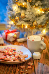 Christmas tree and gifts with lights and frozen window