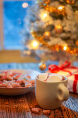 Gorgeous Christmas tree and gifts with lights and frozen window