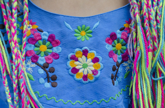 Mexican embroidery with colored thread on a blue background.