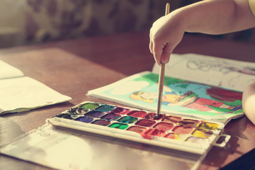 children paint with watercolor