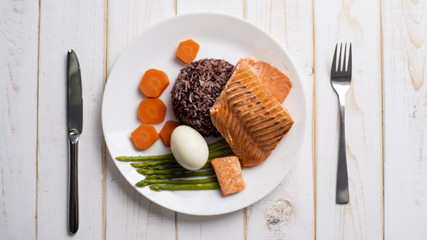 Health food concept, salmon with rice and vegetable on wood background