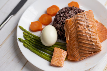 Health food concept, salmon with rice and vegetable on wood background