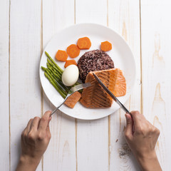 Health food concept, salmon with rice and vegetable on wood background