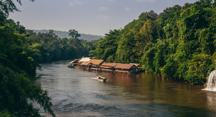 River in the jungle and the floating village on the background of the boat, KANCHANABURI Province of Thailand