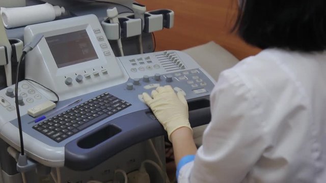 Woman doctor working behind the ultrasound device.4K