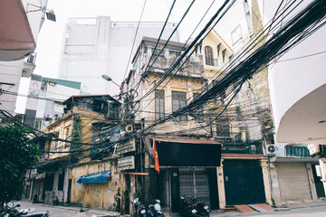 Deserted street of the metropolis is filled with wires and garbage, Hanoi, Vietnam