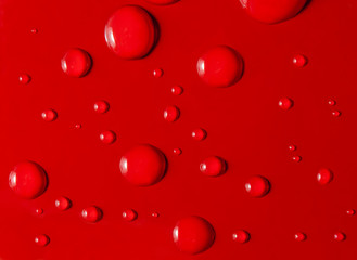 Water drops on red metallic background