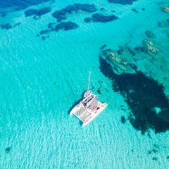 Drone aerial view of catamaran sailing boat in Maddalena Archipelago, Sardinia, Italy. Maddalena...