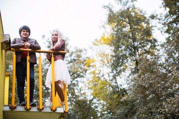 Boy and girl teenagers in autumn park
