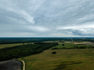 Fototapeta na wymiar drone image. aerial view of rural area with fields and forests under dramatic storm clouds forming