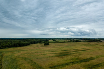 Naklejka premium drone image. aerial view of rural area with fields and forests under dramatic storm clouds forming