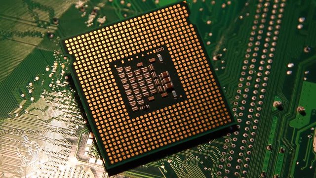 closeup of Computer Chip Processor over electronic green circuit rotating on dolly. 4K UHD Video. Nikon D500