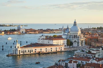 Fototapeten Saint Mary of Health basilica in Venice and Punta della Dogana, aerial view at sunset in Italy © andersphoto