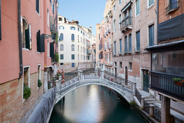 Fototapeta na wymiar Venice, ancient buildings and calm water in the canal, nobody in the morning in Italy