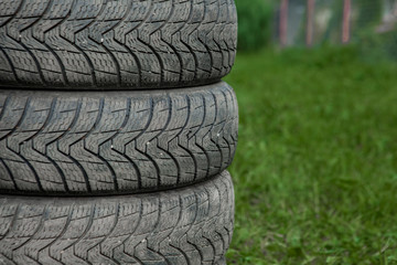 Winter tires close-up . Tires on green background