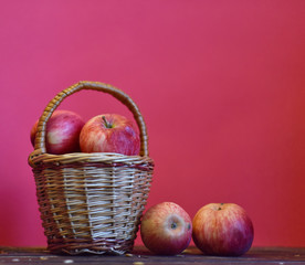 ripe red apples on pink background
