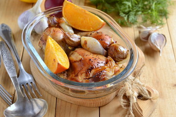 Baked in the oven chicken with orange, garlic and onion