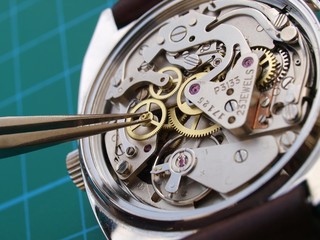 close up of watchmaker repairing a vintage watch