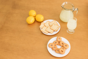 lemonade with cookies on wooden table