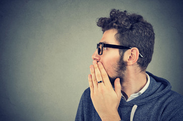 Man whispering private information a secret