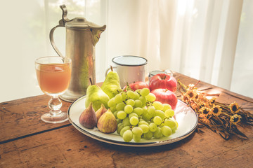 Healthy breakfast with fruits, warm autumn light