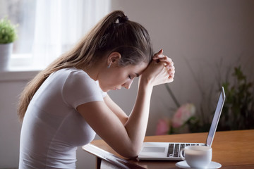 Sad young woman sit at laptop broken after reading bad news online, upset girlfriend hurt receive...