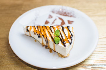 curd dessert with fruits and mint on a white plate