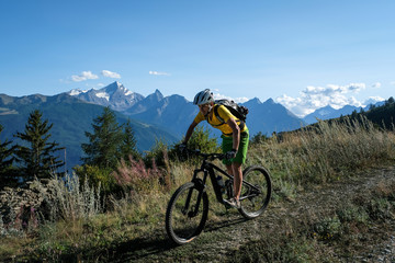 Naklejka na ściany i meble mountainbiker in action in the beautiful aosta valley, Italy, Europe