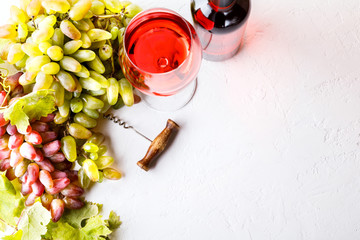 Grapes of Vine and Glass of Pink Wine on the White Background. Autumn mood.Copy space for Text.