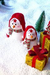 Merry Christmas and happy New Year greeting card. Christmas background with Christmas tree and snowman.