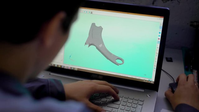 Close-up of the Engineer Holding Laptop with CAD Component Model on Screen.