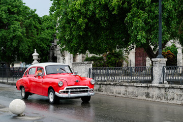 Old classic car on a colonial Old Havana avenue