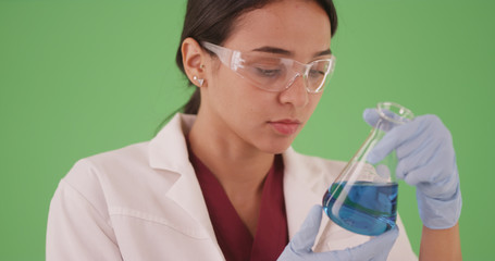 Fototapeta premium Young female scientist or medical researcher with blood samples on greenscreen