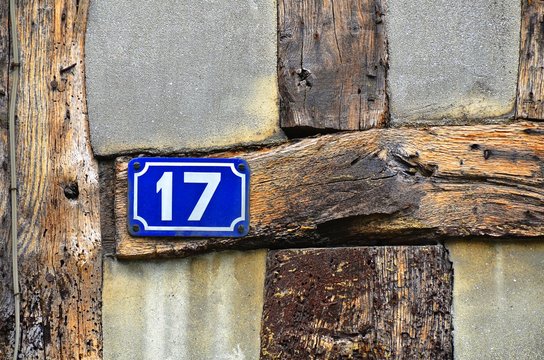 house number 17 on antique rustic wall, old, rusty enamel sign
