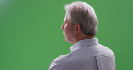 Closeup of mature caucasian man looking away from camera on greenscreen - Powered by Adobe