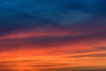 Naklejka na ściany i meble Dramatic sunset sky with blue and red clouds