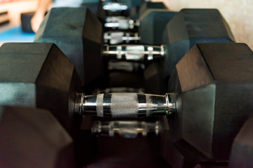 Closeup image of big black chrome dumbbells