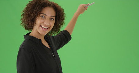 Confident millennial african American teacher giving lesson on green screen