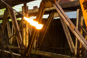 Cutting metal with a gas burner.
