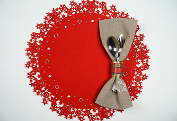 Top view Christmas And New Year Holiday Table Place Setting. Red woolen background. Winter holidays...