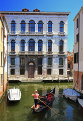 Fototapeta na wymiar Couple ride on gondola in Venice, Italy