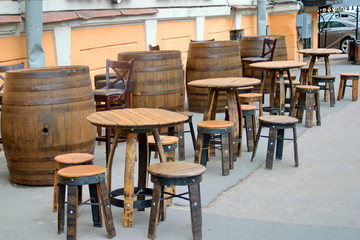 Temporary street cafe with retro chairs and tables made of barrels. Saint Petersburg, Russia.