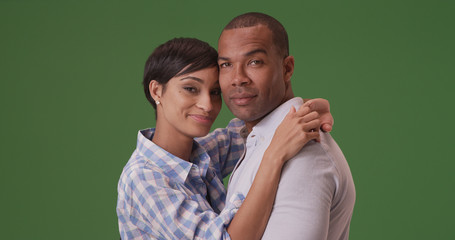 African American couple pose for a portrait on green screen