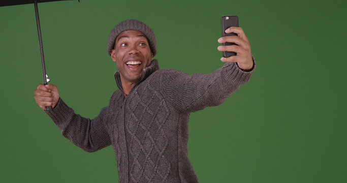 An African American Man Takes A Selfie In The Rain On Green Screen