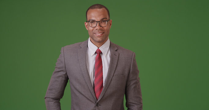 A Black Businessman Poses For A Portrait On Green Screen