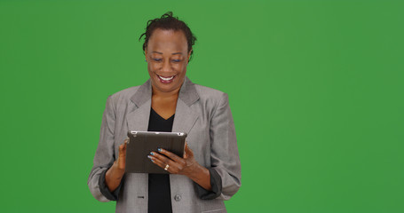 African-American business professional using pad device on green screen