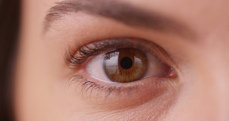 Extreme close up of young woman's eye on green screen