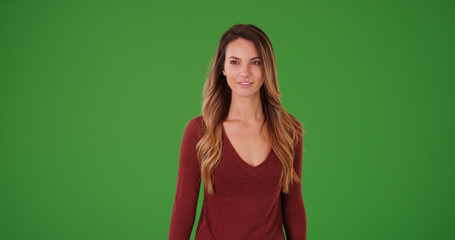 Attractive young Caucasian female standing on green screen